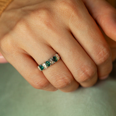 18k white gold ring with three oval natural alexandrites and baguette diamonds on finger